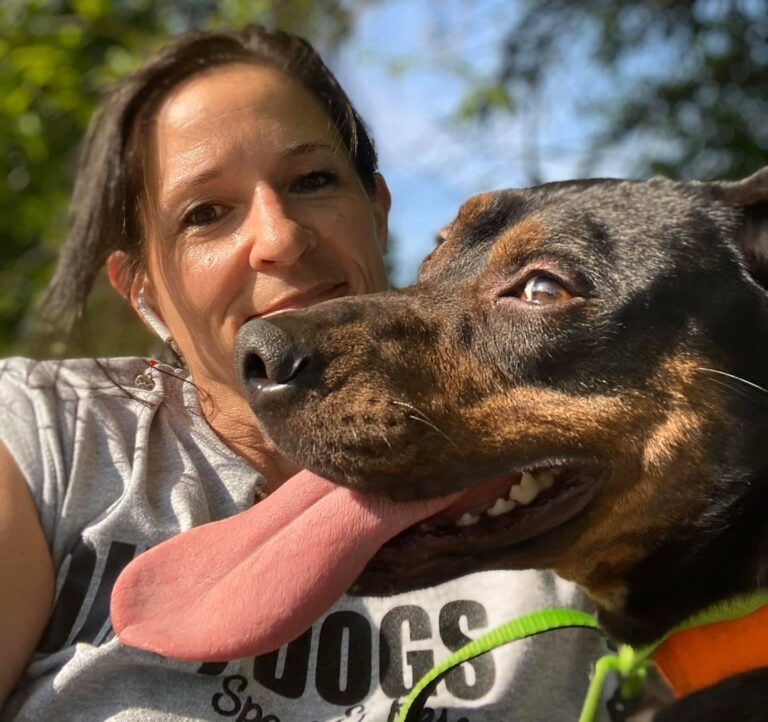 A member of the Pearl's Place team with a rescue dog
